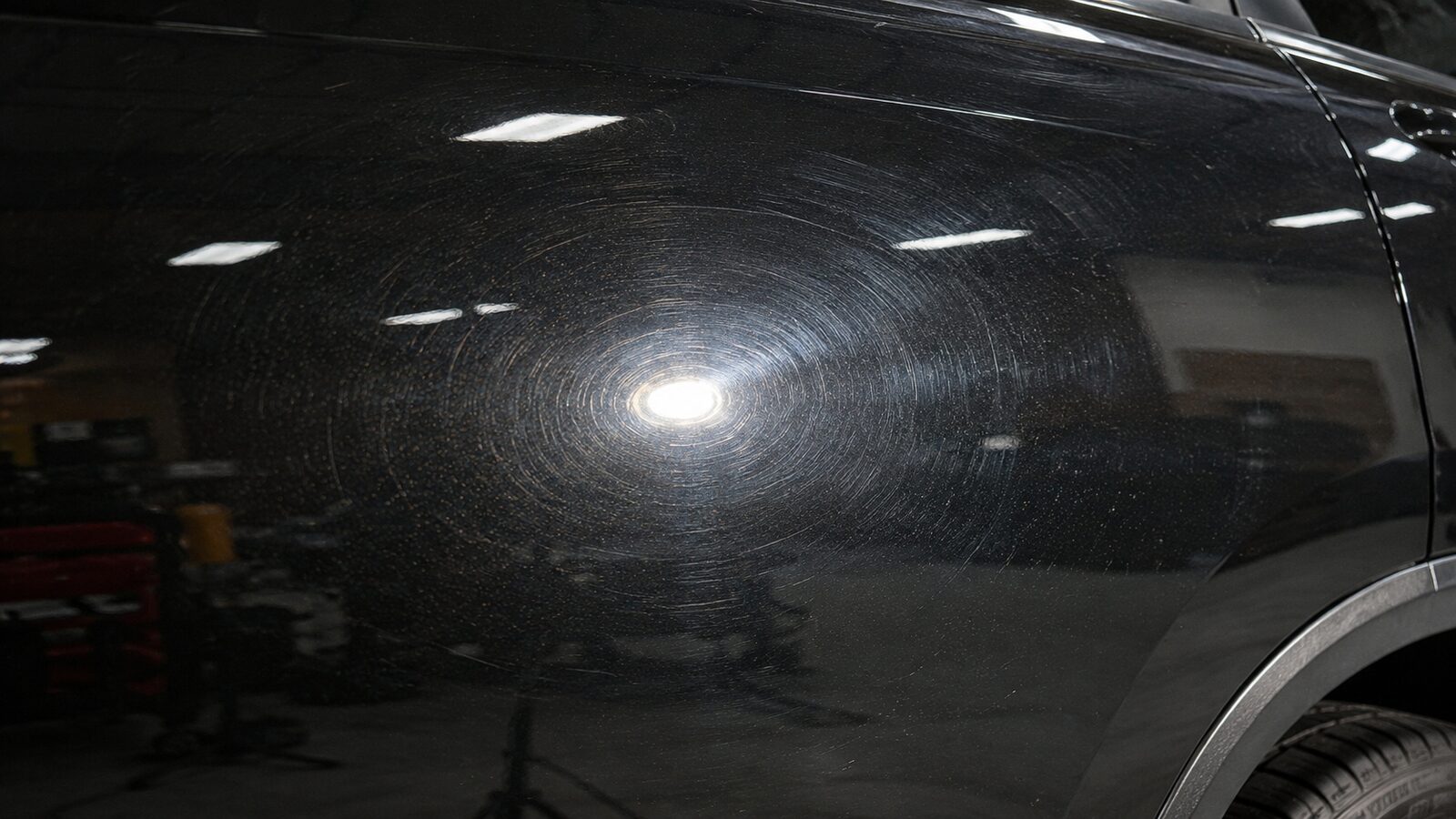 Before correction. Spider-webbed swirl marks under direct light.