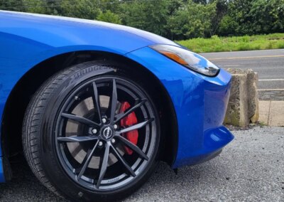 A car with open doors undergoing a thorough detailing at Total Detailing Auto Spa.