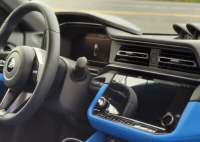 A shiny black car with detailed exterior after professional auto detailing service.