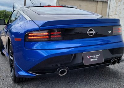 A red sports car getting detailed at Total Detailing Auto Spa.