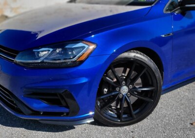 A clean and shiny black car after detailing service.