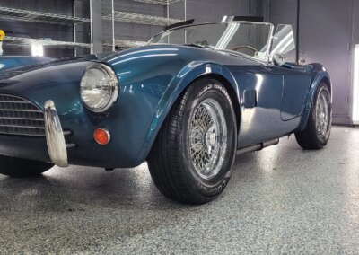 Car with glossy finish after detailing in a garage.