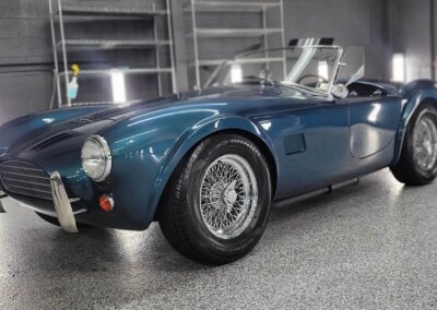 A car covered in foam during an auto detailing process.