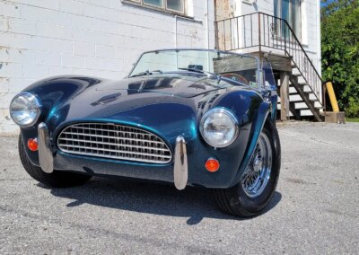 A car with open trunk receiving a professional auto detailing service.