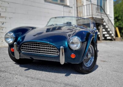 A clean and shiny black car after detailing service.