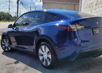 Car detailing products on a shelf in a garage.