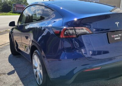 A clean and shiny black car after detailing service.