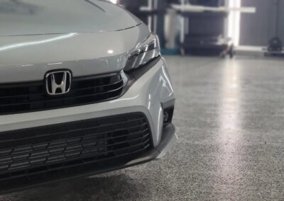 A car being detailed in a professional auto detailing shop.