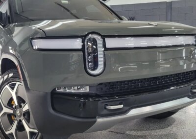 A car with open doors being detailed and cleaned by a professional at Total Detailing.