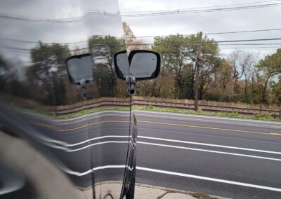 A car with open doors being detailed by a professional at Total Detailing.