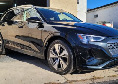 A car being detailed by a professional with cleaning equipment.