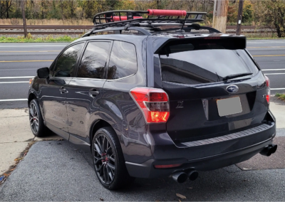 A Subaru Forester with tinted windows parked outdoors.