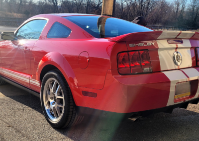 A car being detailed by a professional with cleaning equipment.
