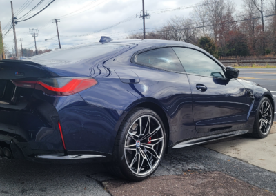 A car with a shiny and polished exterior after detailing service.
