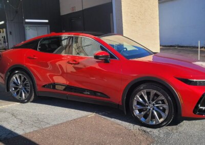 A car undergoing detailing in a well-equipped garage.