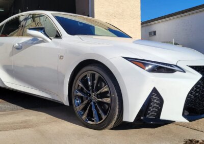 A car undergoing detailing service in a garage.