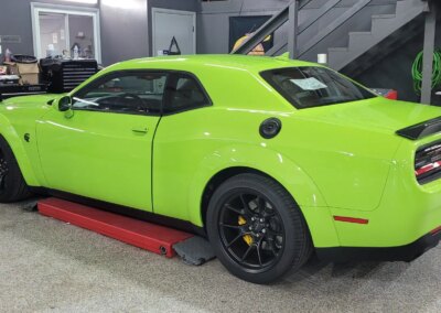 A red car being detailed by a professional at Total Detailing PA.