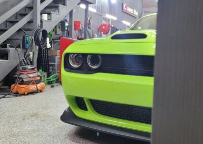 A car being detailed with cleaning products at Total Detailing Auto Spa.