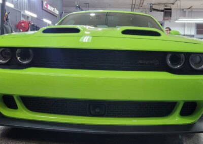 A car covered in snow parked outside on a winter day.