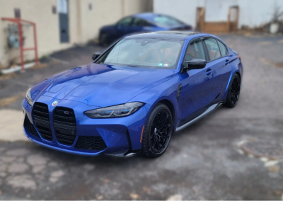 A shiny black car after being detailed at Total Detailing.