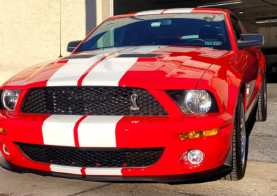 A blue car getting detailed and polished by a professional at Total Detailing.