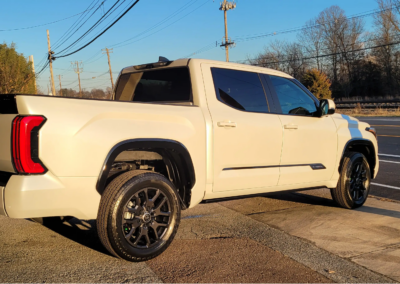 Car being washed with foam at a detailing service.