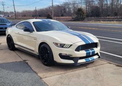 A red sports car getting detailed at Total Detailing Auto Spa.