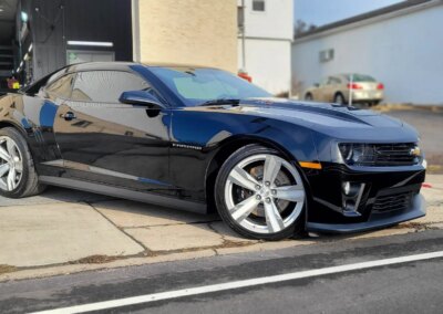 A red sports car getting detailed at Total Detailing in Pennsylvania.