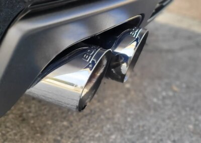 A car undergoing detailing in a well-equipped garage.