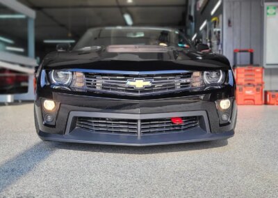A clean and shiny black car after detailing service.